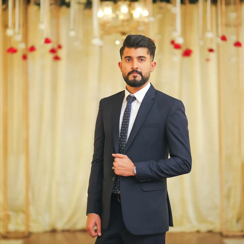 An Indian chartered accountant in a navy suit